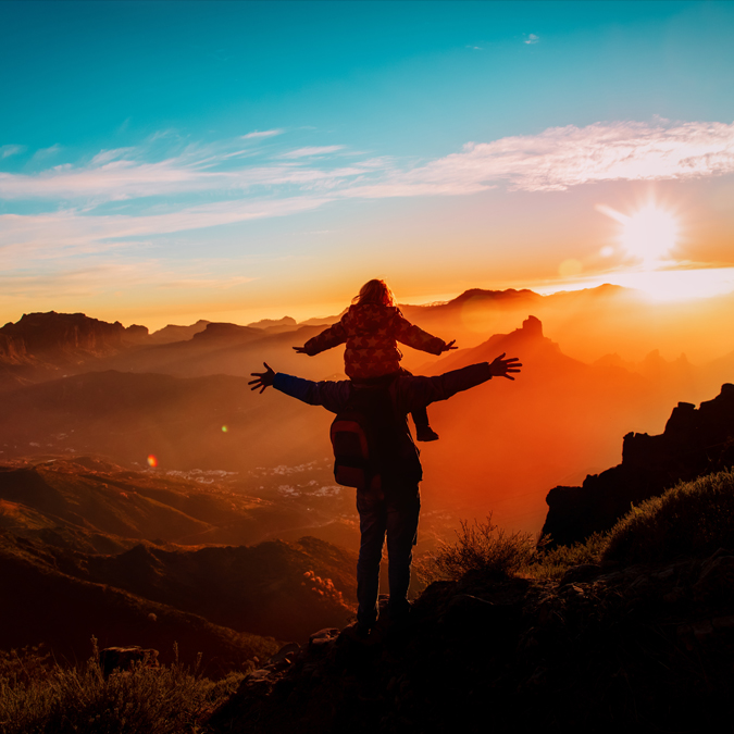 father and daughter enjoy sunset