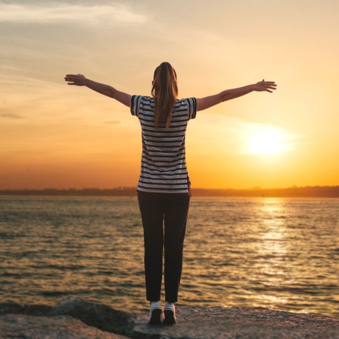 woman enjoys sunset