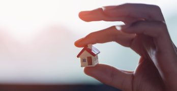 House model with man's hand