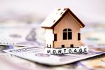 finance concept in blocks with word Mortgage and wooden symbol