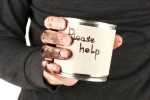 homeless man asks for help, on black background close-up