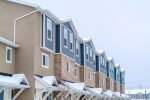 Apartment building with covered entrances against cloudy sky on a winter day