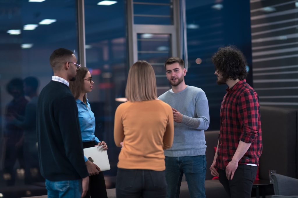 Successful team. Group of young business people working and communicating together in creative office. Selective focus