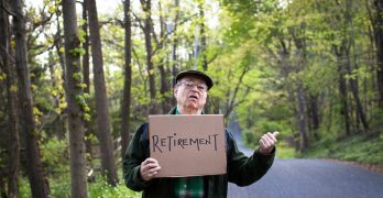 Senior man holding retirement sign