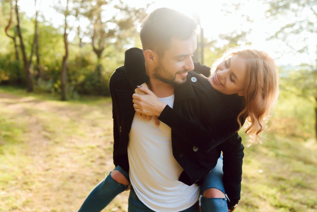 Romantic young couple in love relaxing outdoors in park.