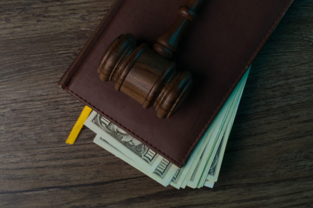 Judge's hammer, folder with banknotes