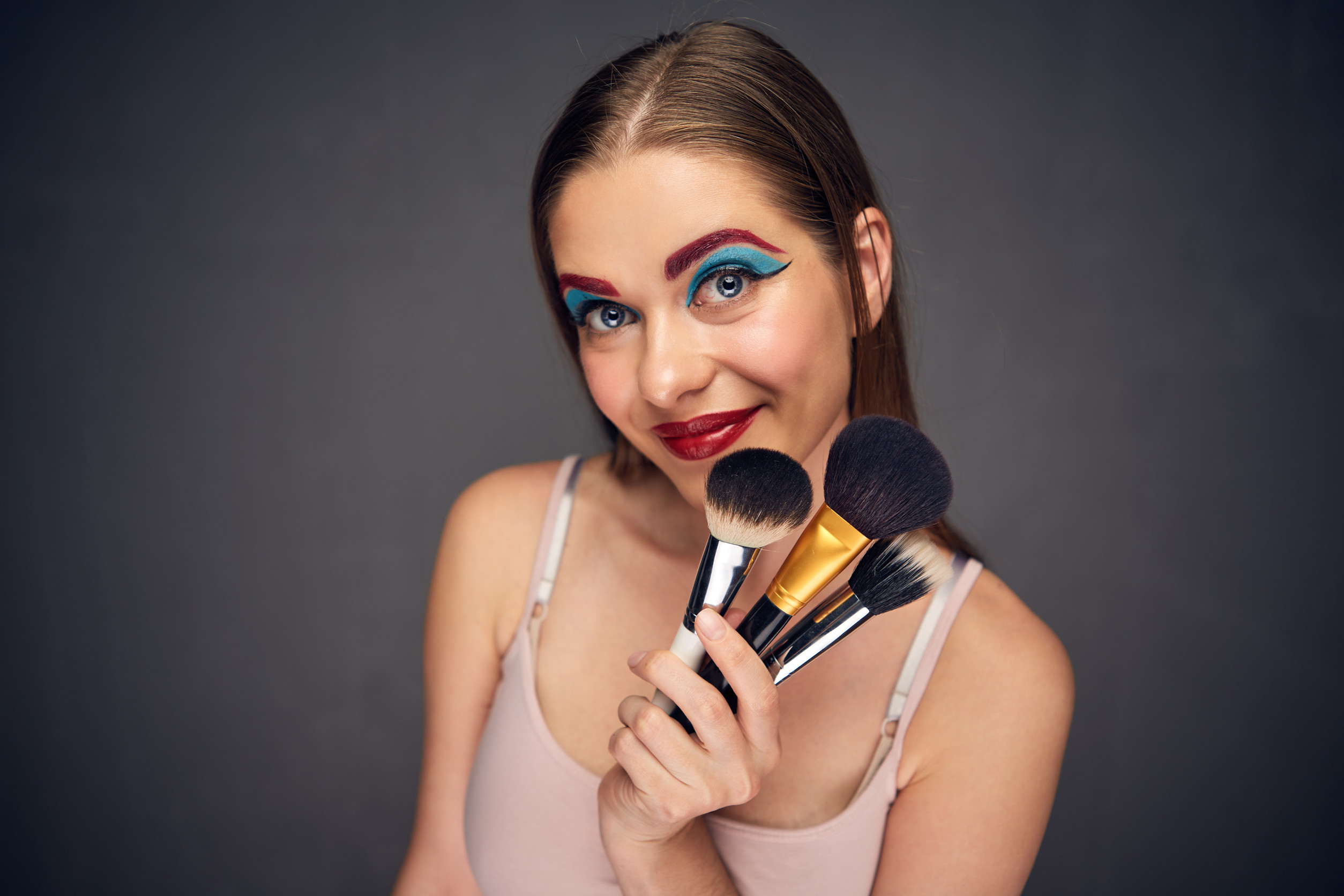 Crazy make up artist with clown worst make up. Woman mistake. Close up face portrait.
